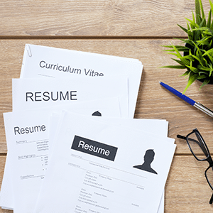 A stack of resumes on a table amid the LinkedIn data breach 2021.