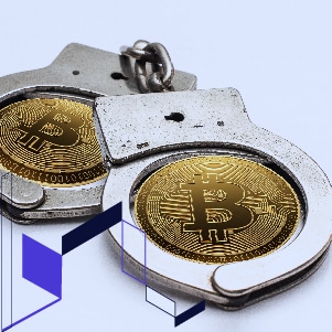 A pair of handcuffs adorned with a bitcoin, symbolizing the connection between Crypto crime and Cryptocurrency scams.