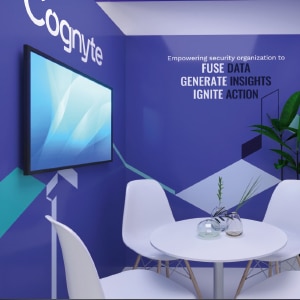 A blue wall with a white table and chairs and a tv.